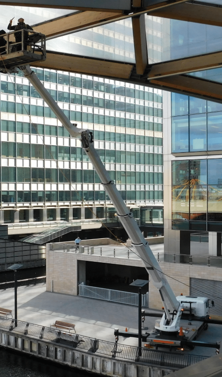 Men cleaning windows on sky scraper building